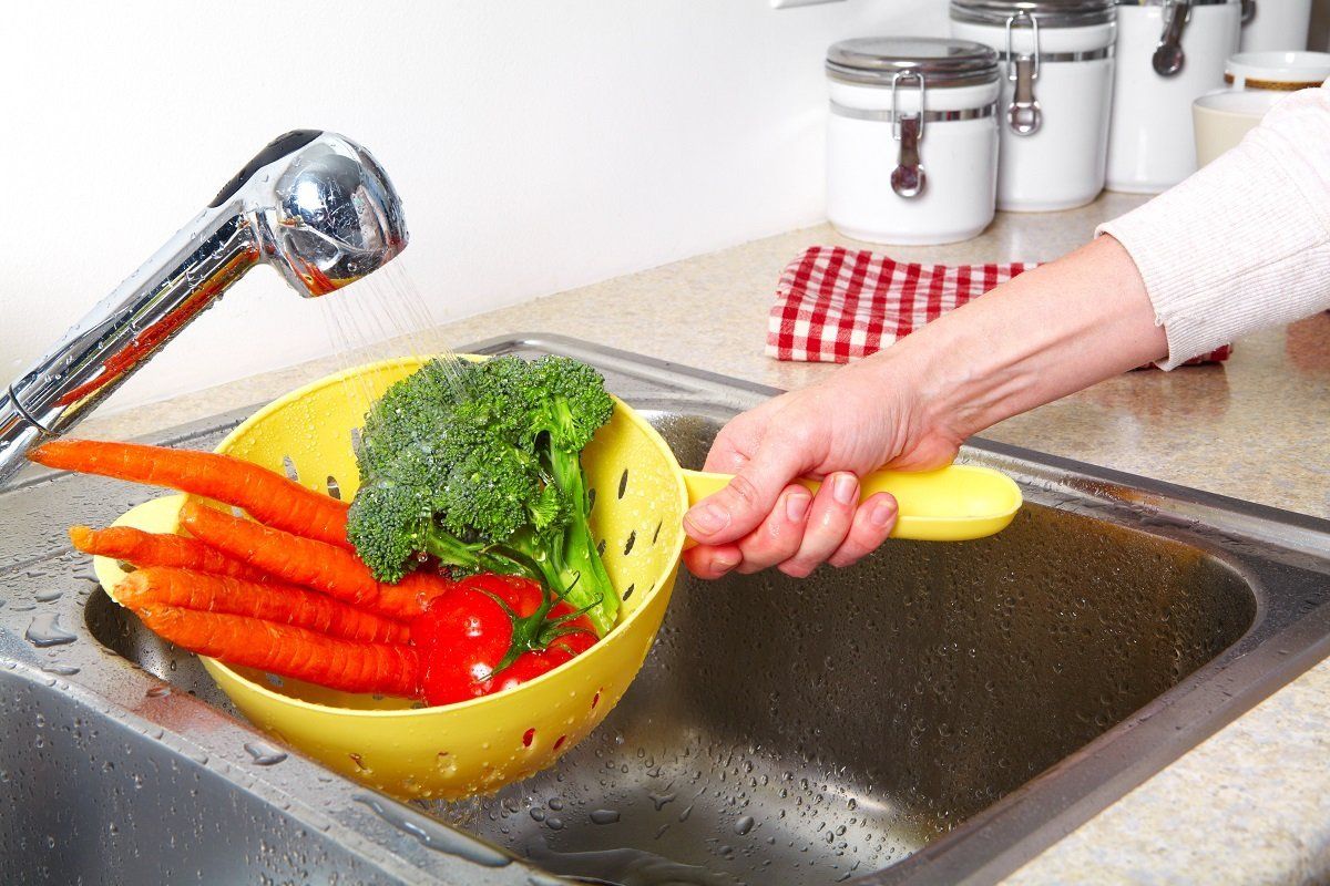 Vegetables in the sink on kitchen. Fresh vegetables