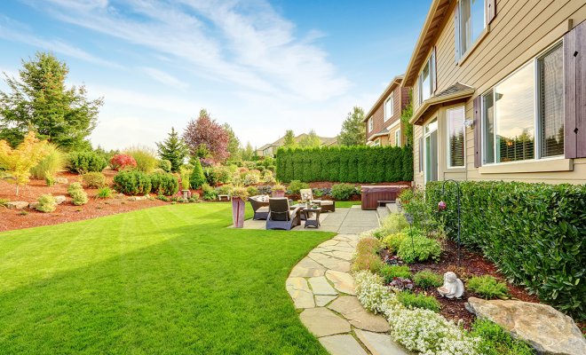 : Impressive backyard landscape design with cozy patio area